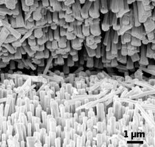 A scanning electron micrograph image shows the interface of two entangled fibers, where millions of tiny nanowire bristles generate electricity upon mechanical deformation.
