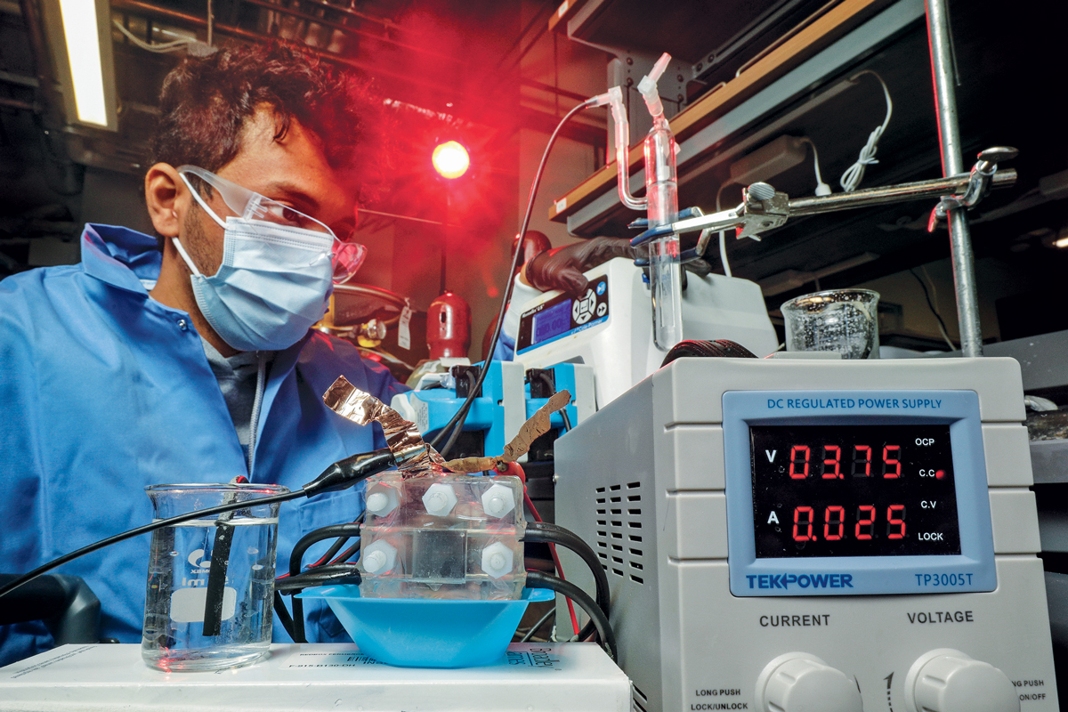 Person in a lab next to an electrodialysis device.
