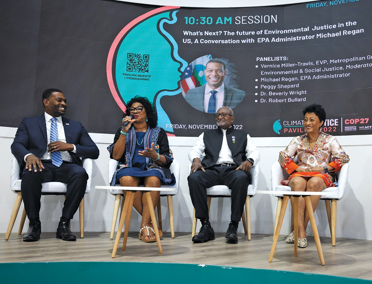 A panel of four people at COP27 discussing the future of enviornmental justice. The photo includes Michael S. Regan, Beverly L. Wright, Robert Bullard, and Peggy Shepard sitting in chairs on a stage.