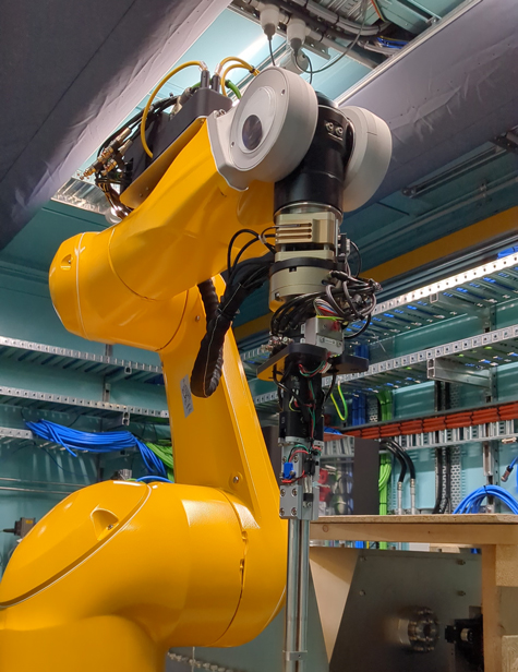 A big yellow robot arm with googly eyes.