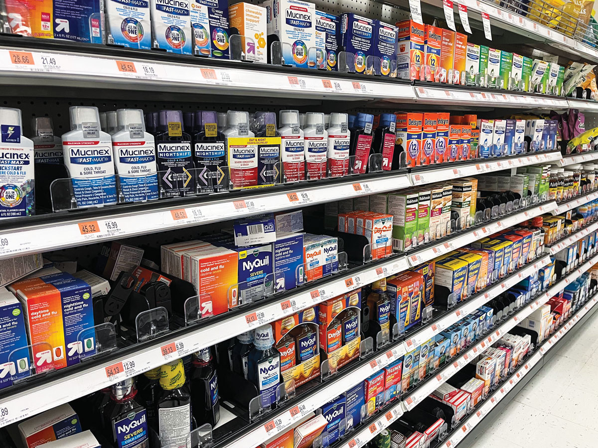 Store shelves full of cough and cold remedies.