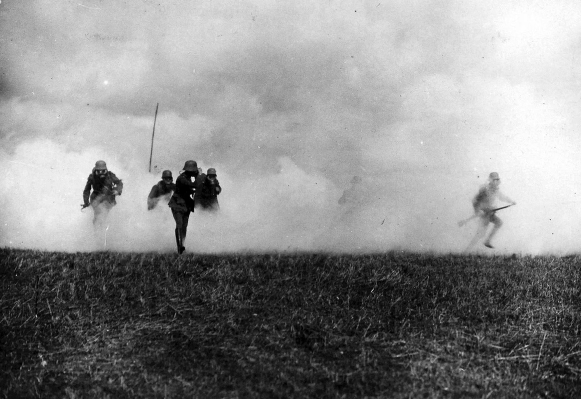 German soldiers run through poison gas during training.