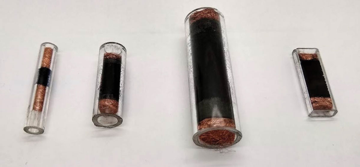 Quartz tubes of different sizes are packed with black material.